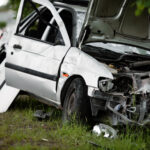 Totaled car on the side of the road